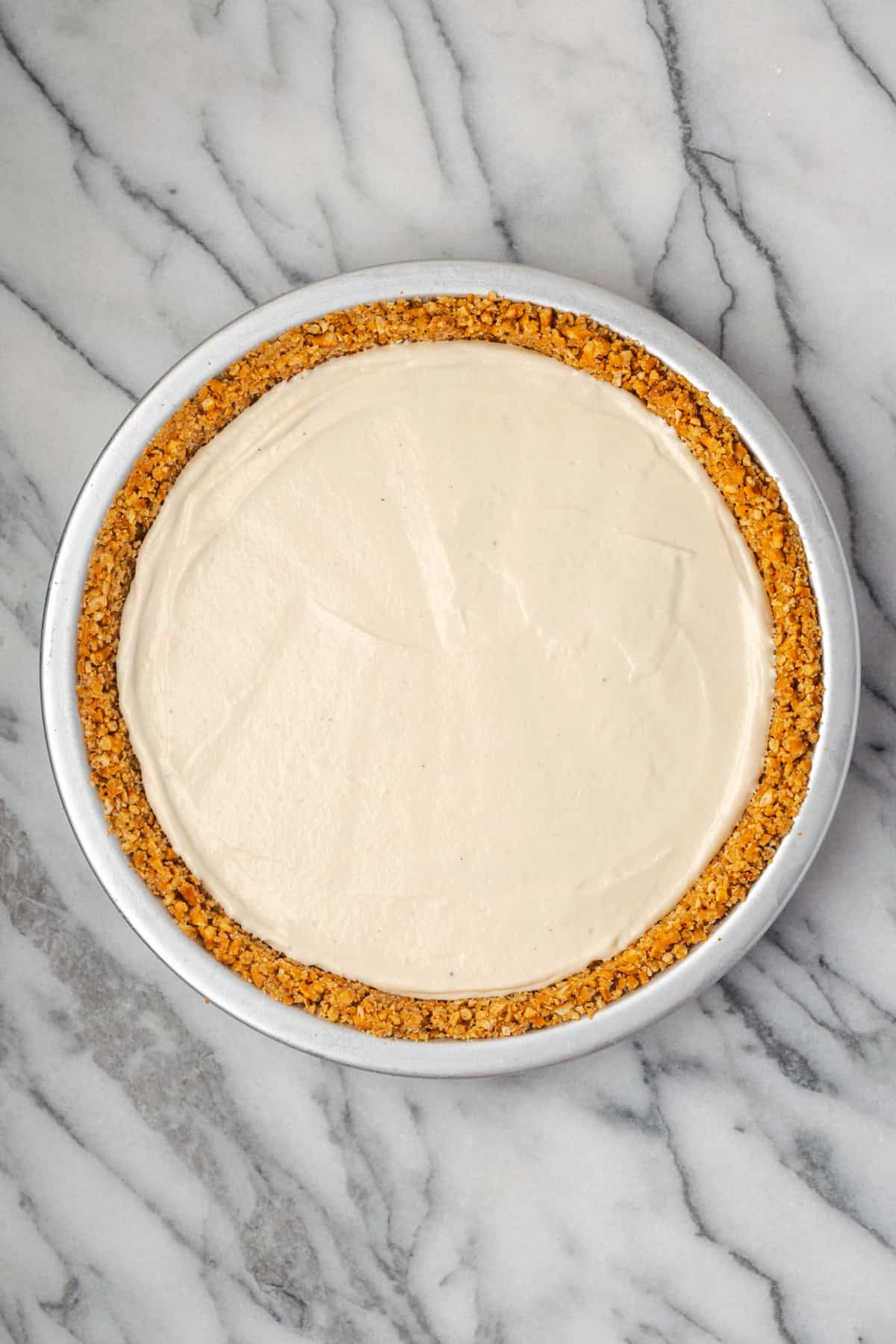 No bake cheesecake mixture spread in a pretzel pie crust. 
