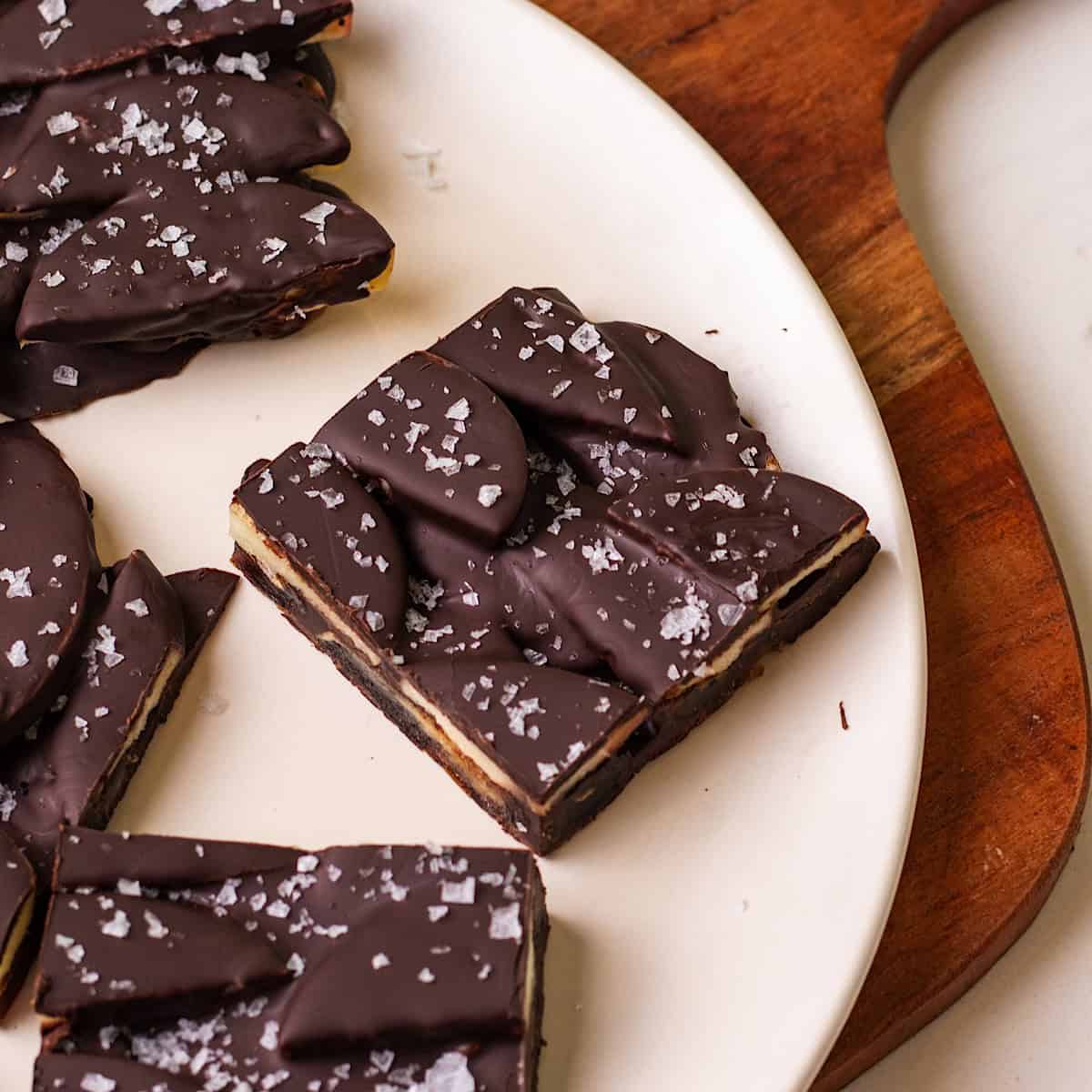 Several pieces are salted caramel apple date bark on a serving tray.