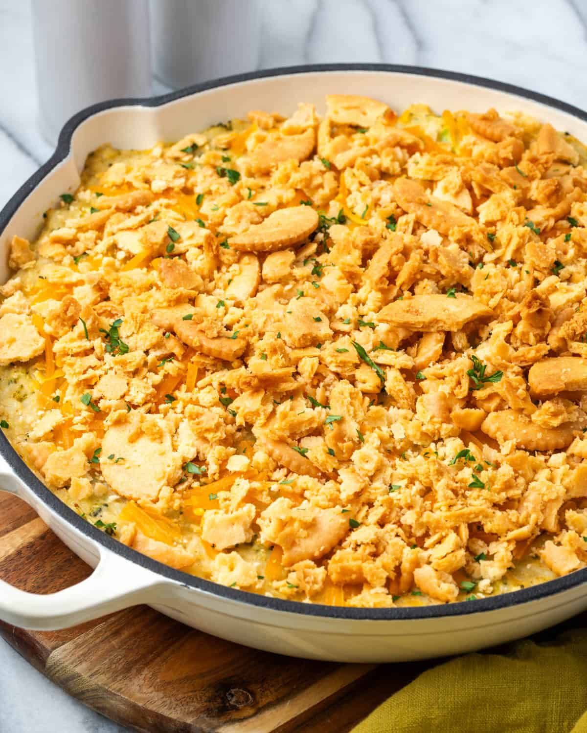 A baked broccoli rice casserole sitting on a wood cutting board. 