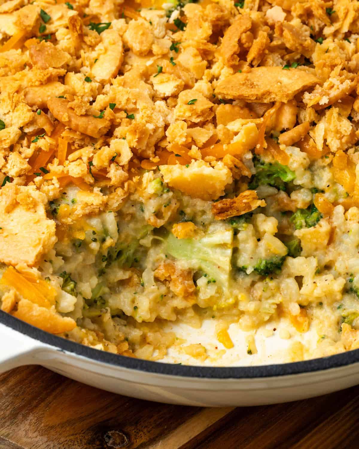 A baked broccoli and rice casserole with a scoop taken out. 