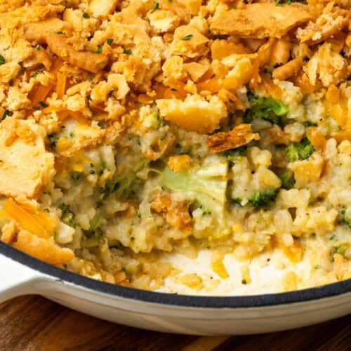 A broccoli rice casserole with a scoop taken out showing the creamy inside.