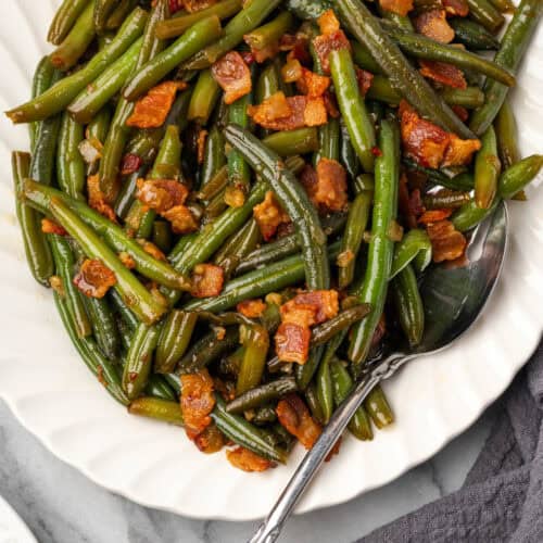 Green beans with bacon and onion on a large serving platter.