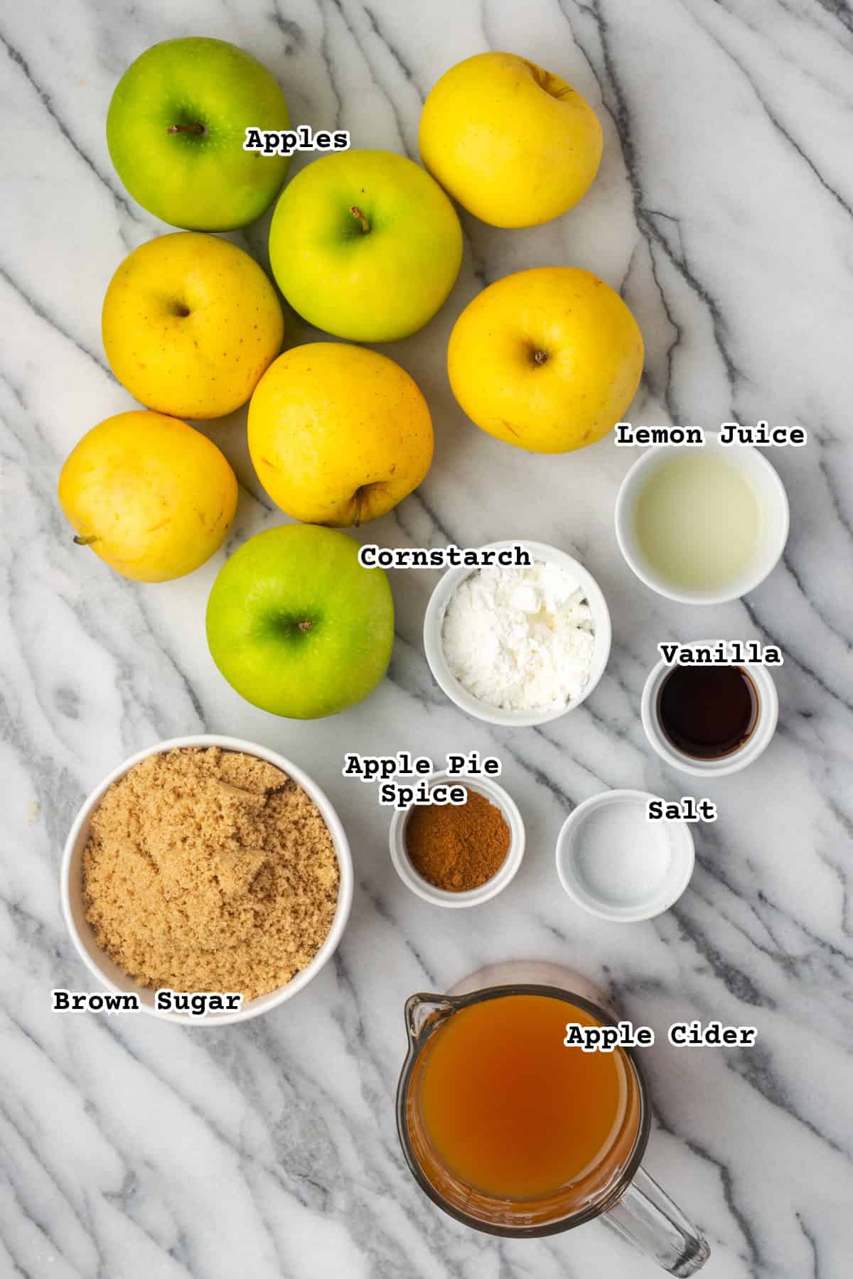 Ingredients for an apple slab pie sitting on a marble counter.
