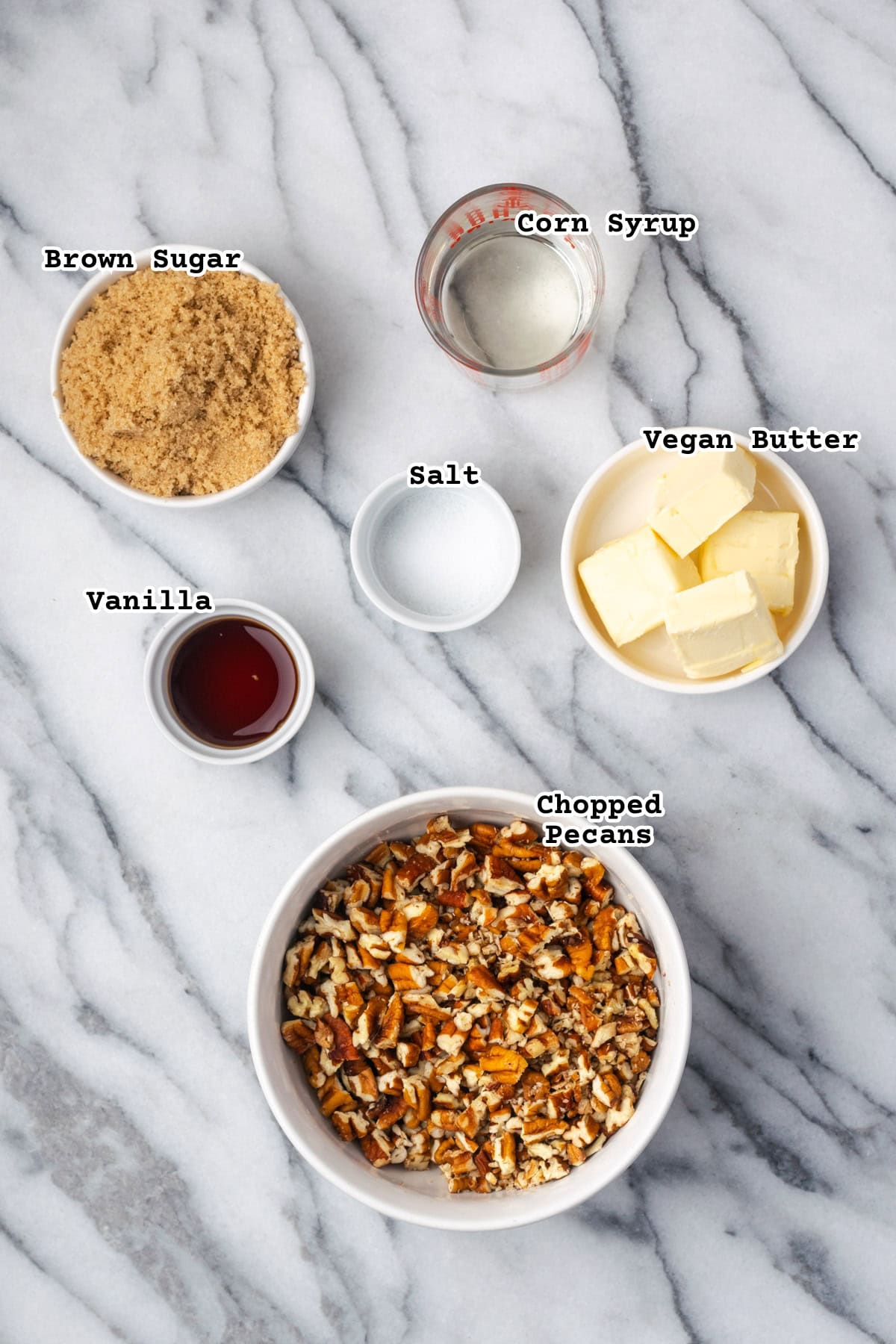 Ingredients for pecan pie brownies on a marble counter.