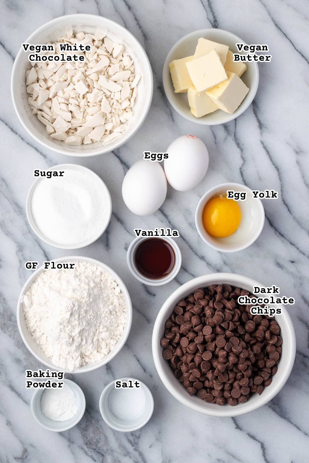 Ingredients for white chocolate blondies with chocolate chips sitting on a marble counter. 