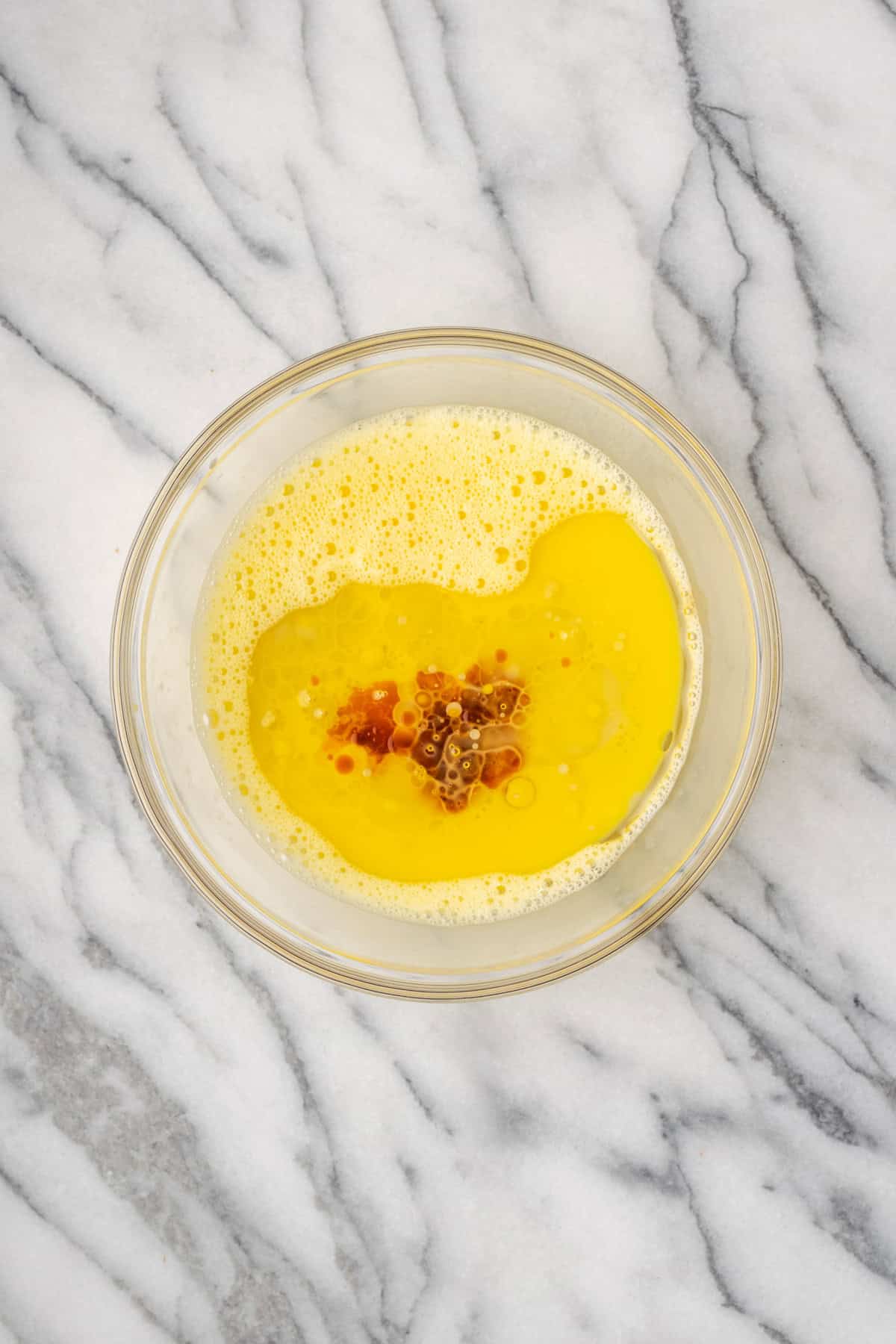 Oil, milk, maple syrup and vanilla added to the bowl with the beaten eggs.