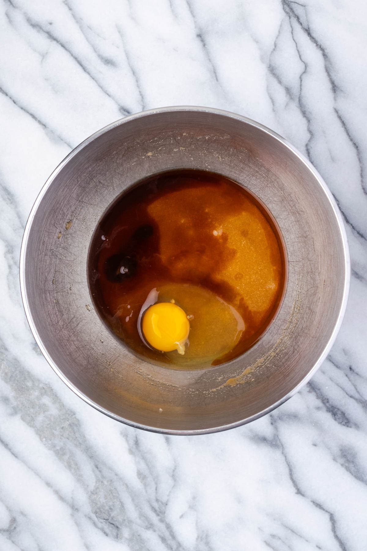 Egg, maple syrup and vanilla added to the bowl with the creamed butter and sugar.