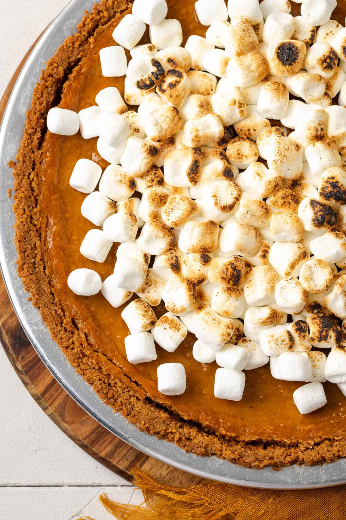 A baked sweet potato pie topped with toasted marshmallows. 