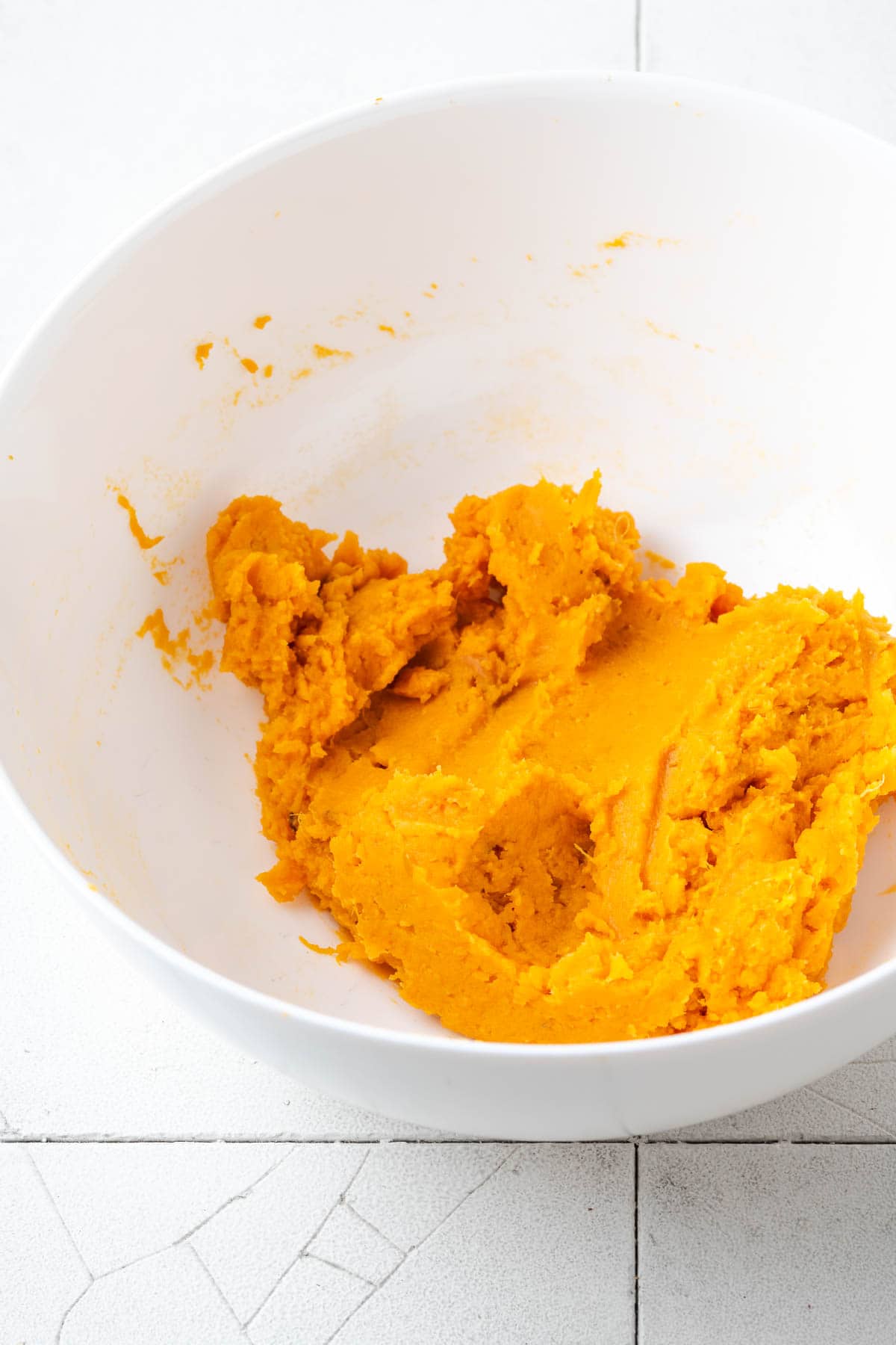 Mashed sweet potatoes in a large mixing bowl. 