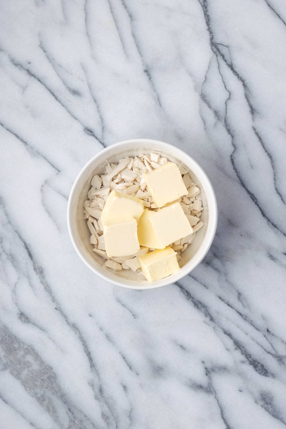 White chocolate and butter combined together in a small bowl. 