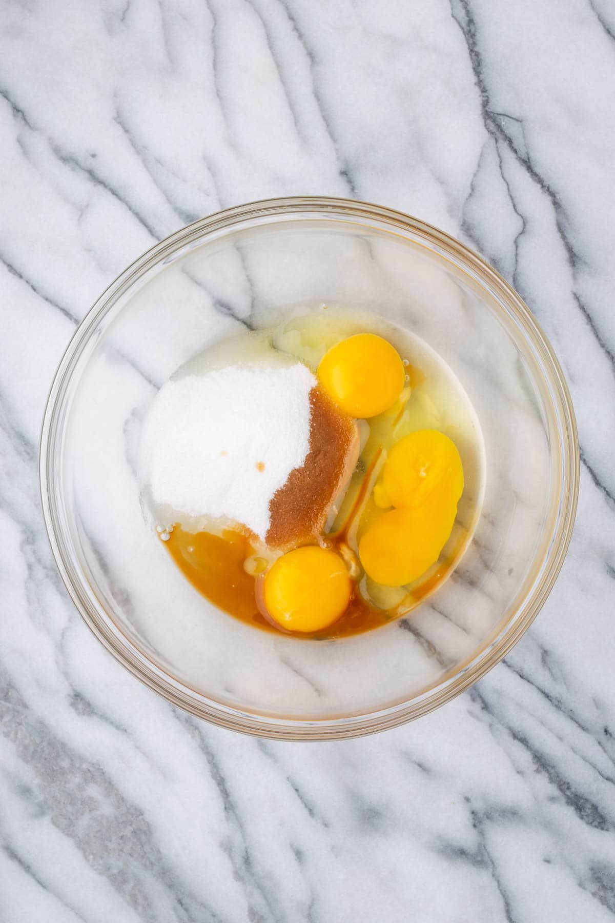 Eggs, egg yolk, sugar and vanilla combined in a large mixing bowl. 