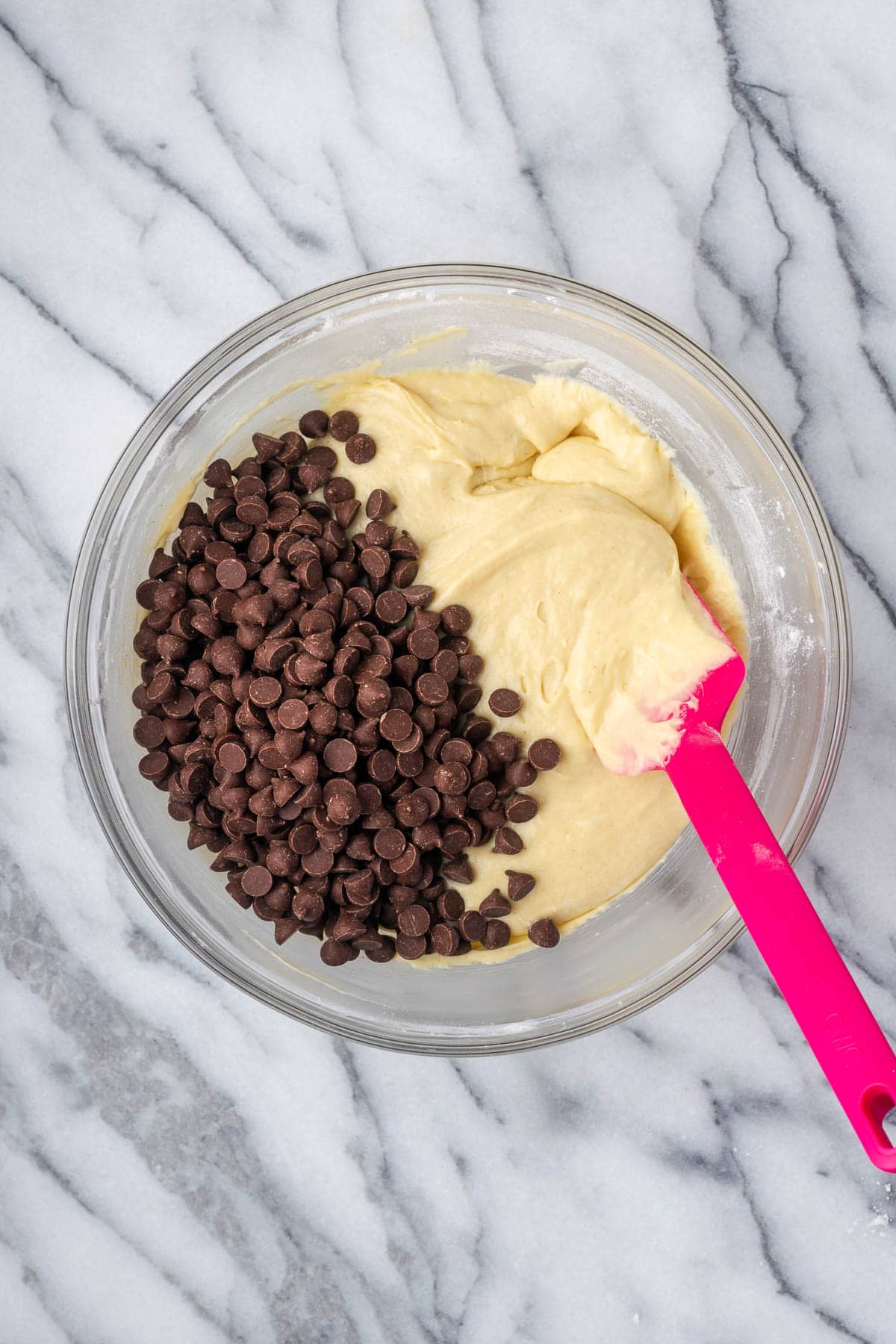 Chocolate chips being stirred into the blondie batter. 