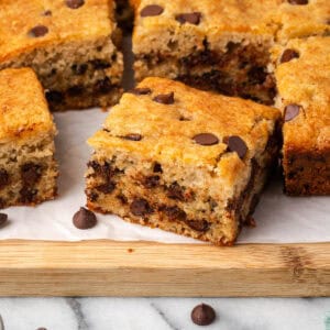 Several slices of banana chocolate chip cake sitting on a wood board.