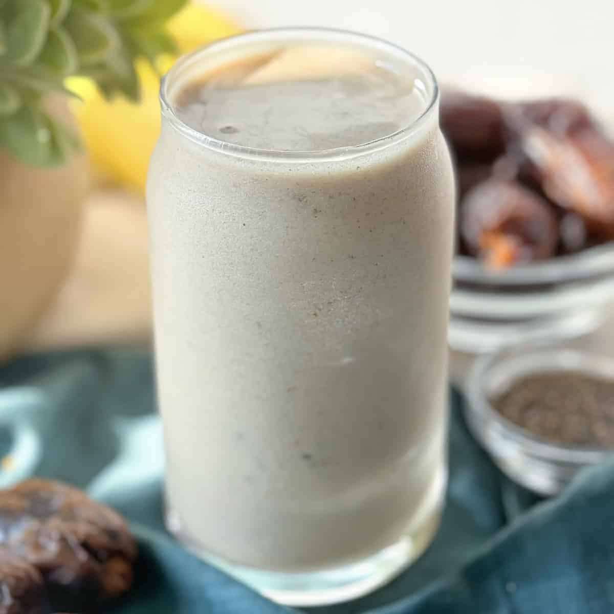 A banana date smoothie sitting on a table.