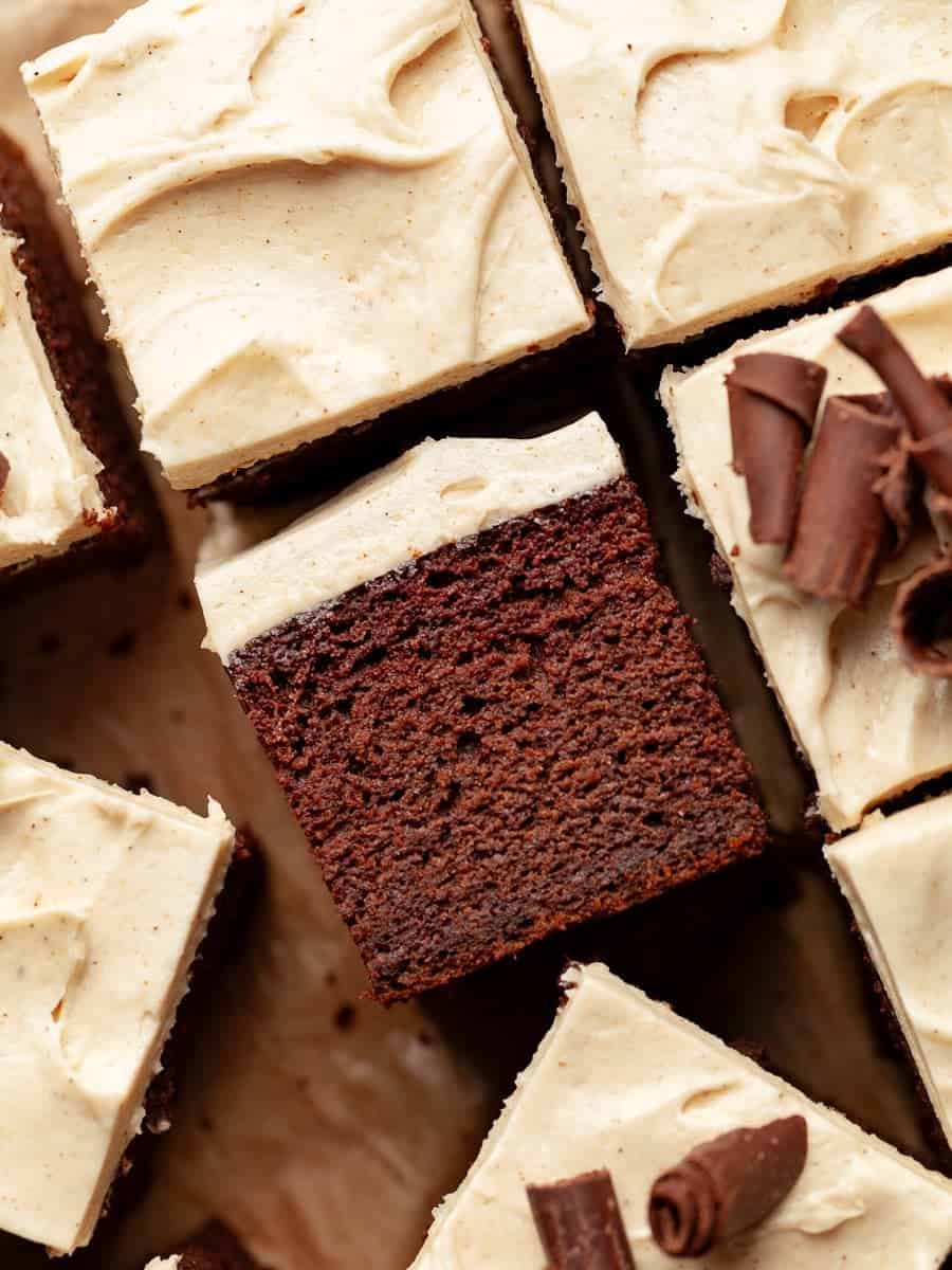 A slice of chocolate pumpkin cake topped with creamy frosting.
