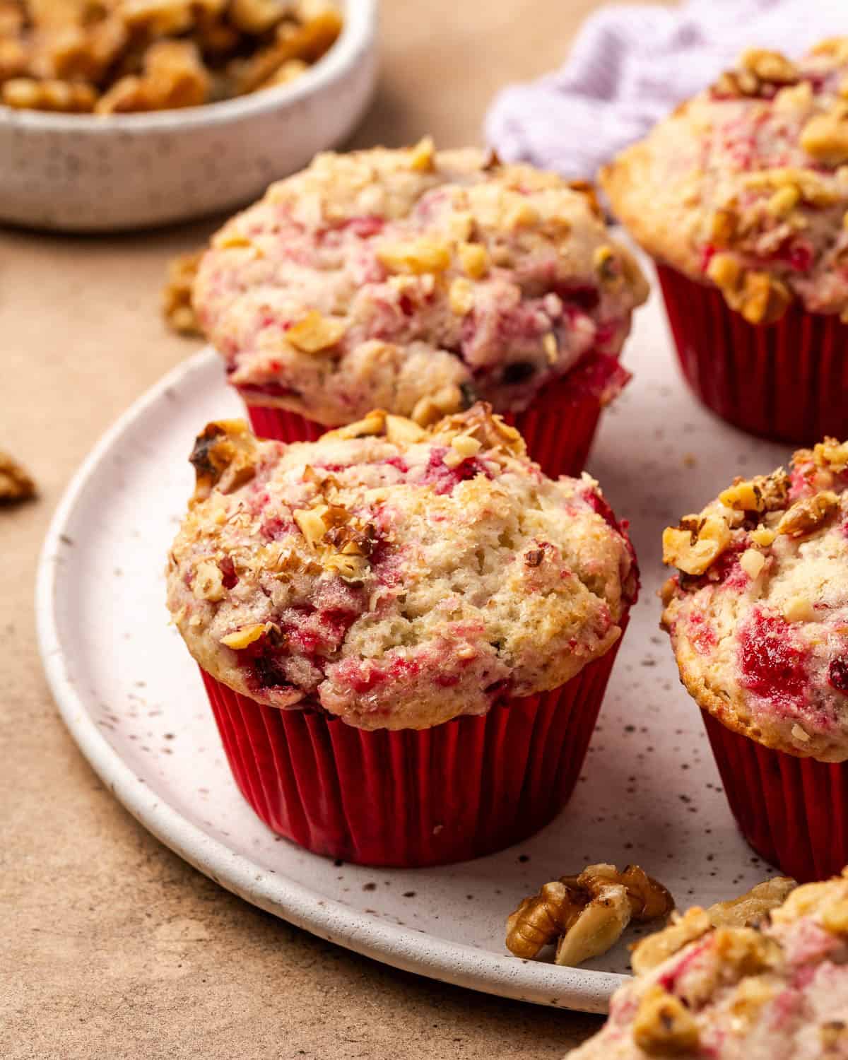 A batch of cranberry sauce muffins on a ceramic serving tray.
