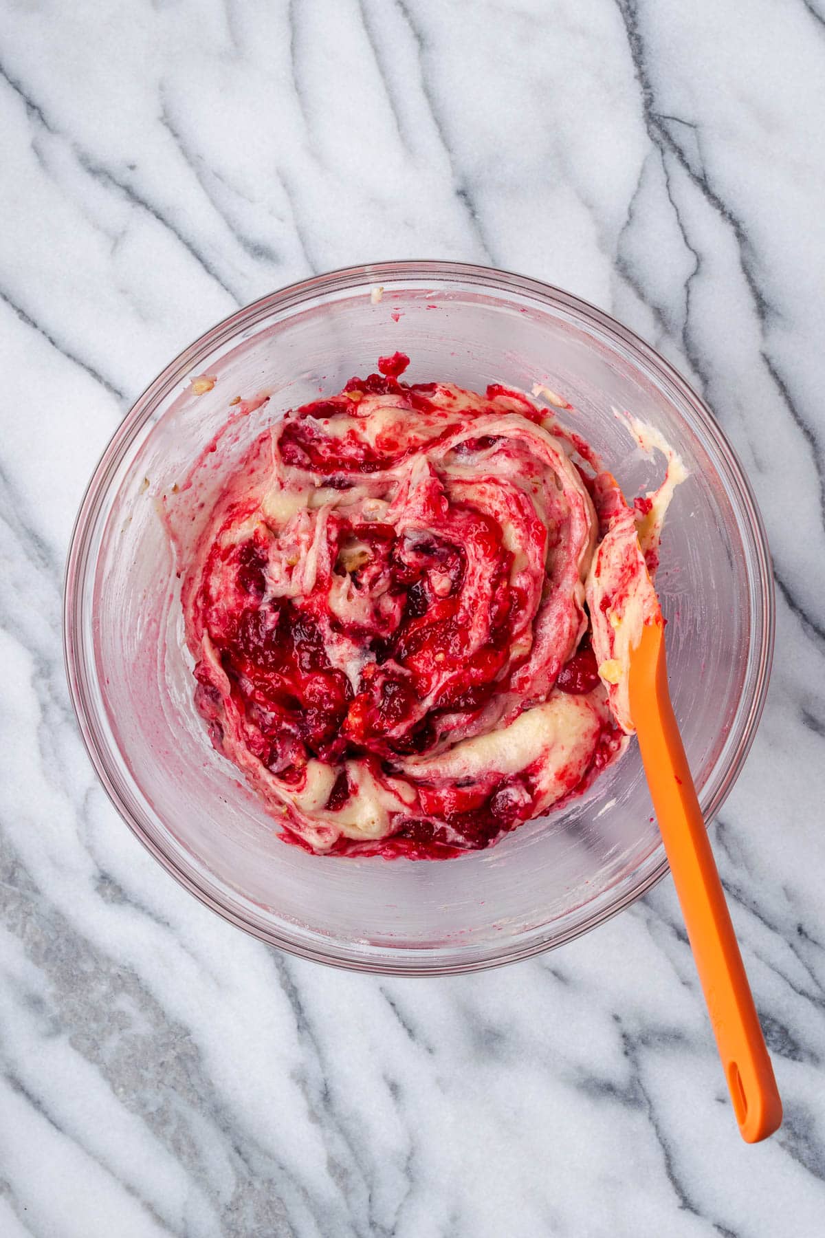 Cranberry sauce muffin batter in a mixing bowl.