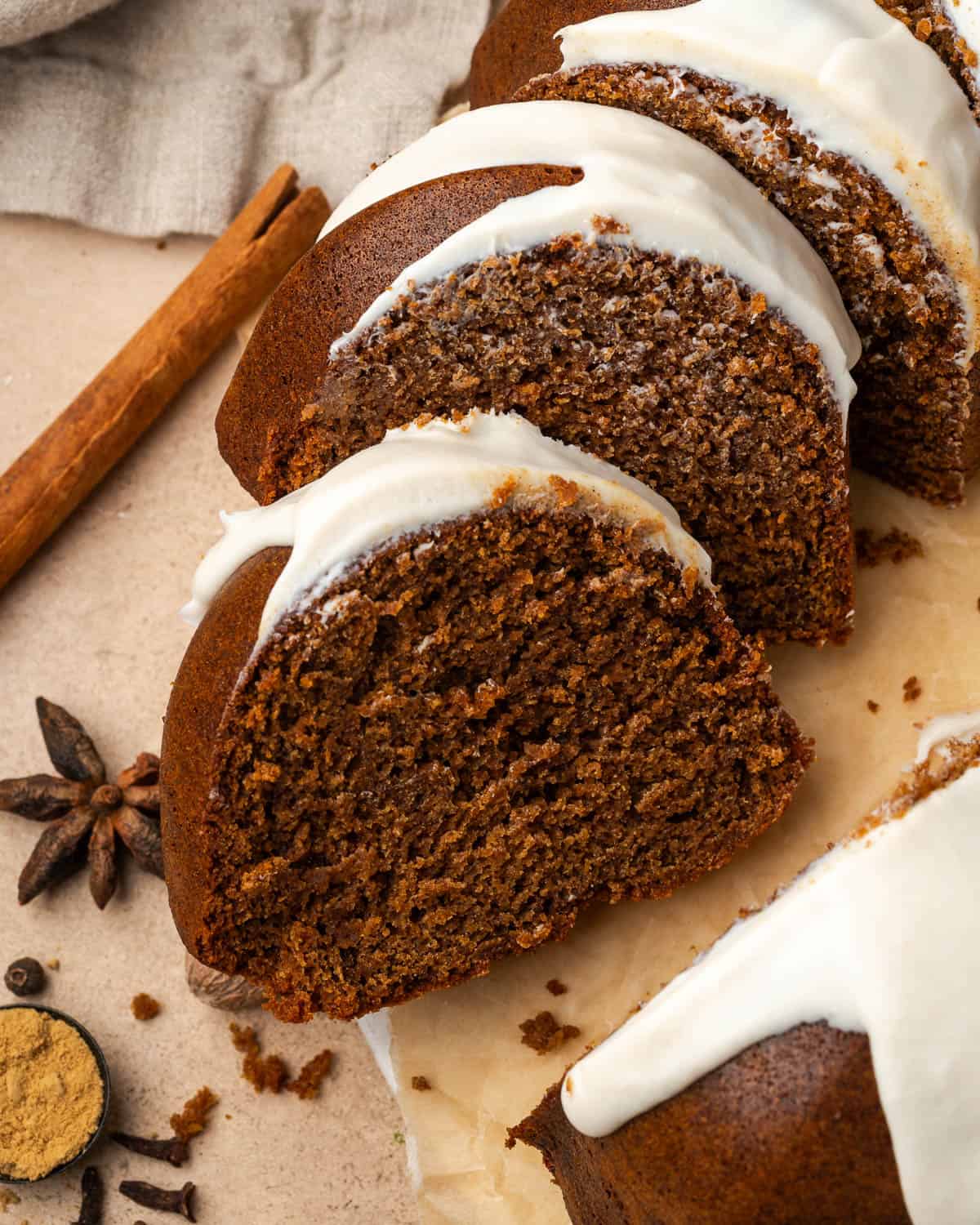 Several slices of a gingerbread bundt cake laying on a serving tray.