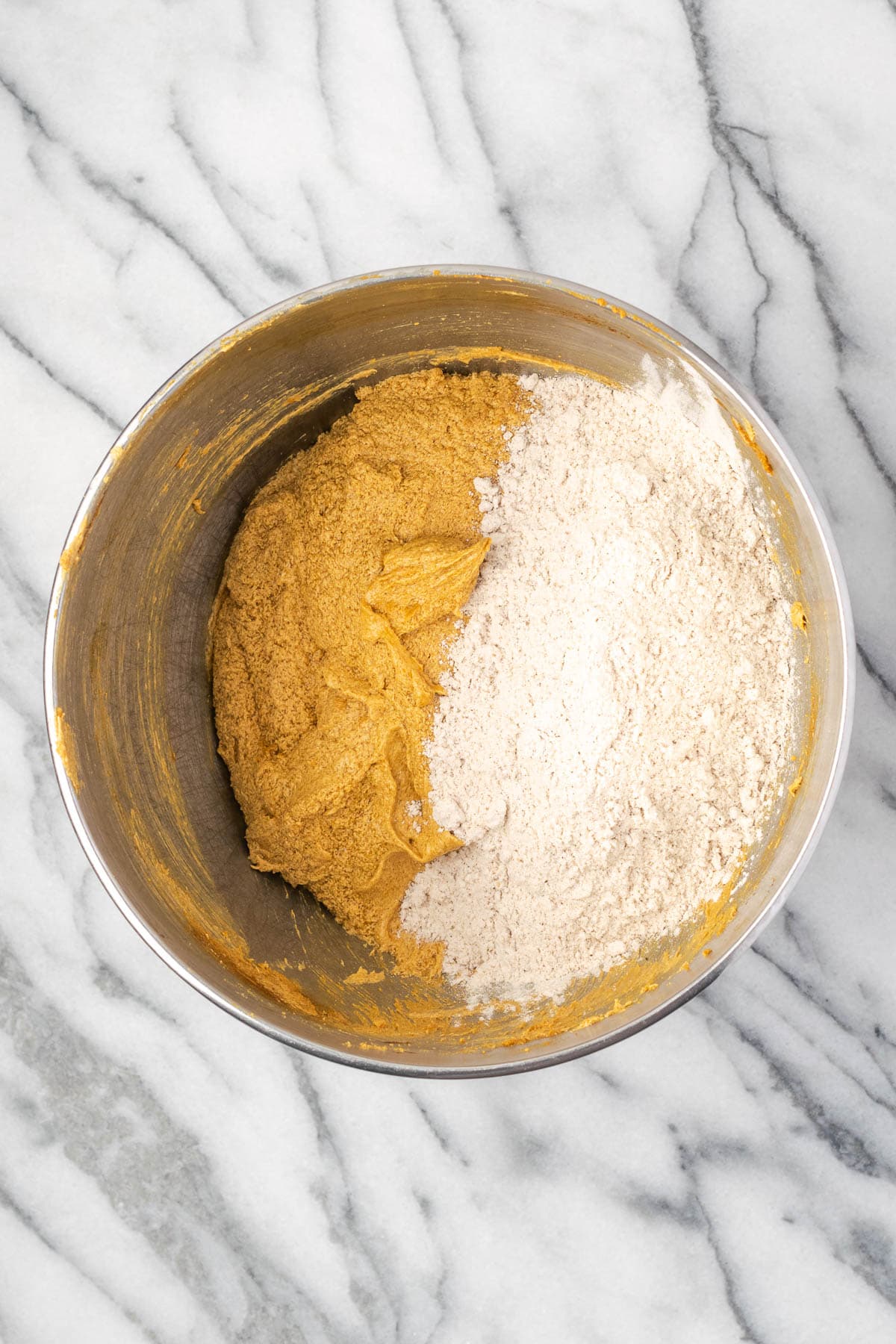 Dry ingredients being stirred into the bowl of wet ingredients.