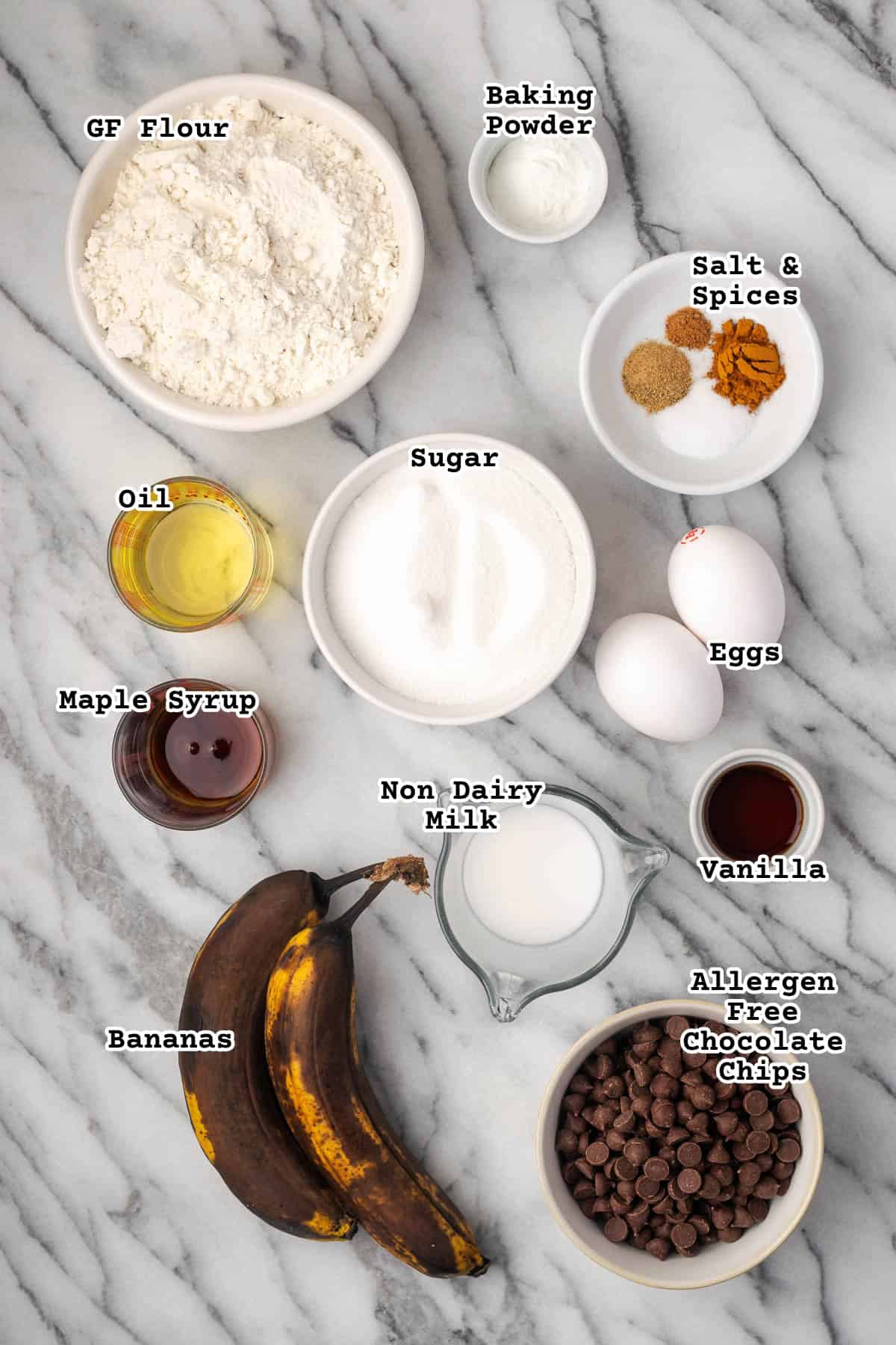 Ingredients for a banana chocolate chip cake sitting on a marble counter.