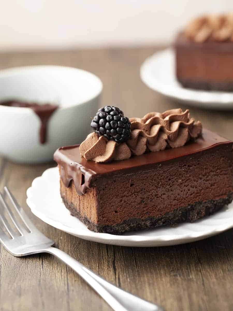 A gluten free chocolate cheesecake topped with a layer of chocolate ganache.
