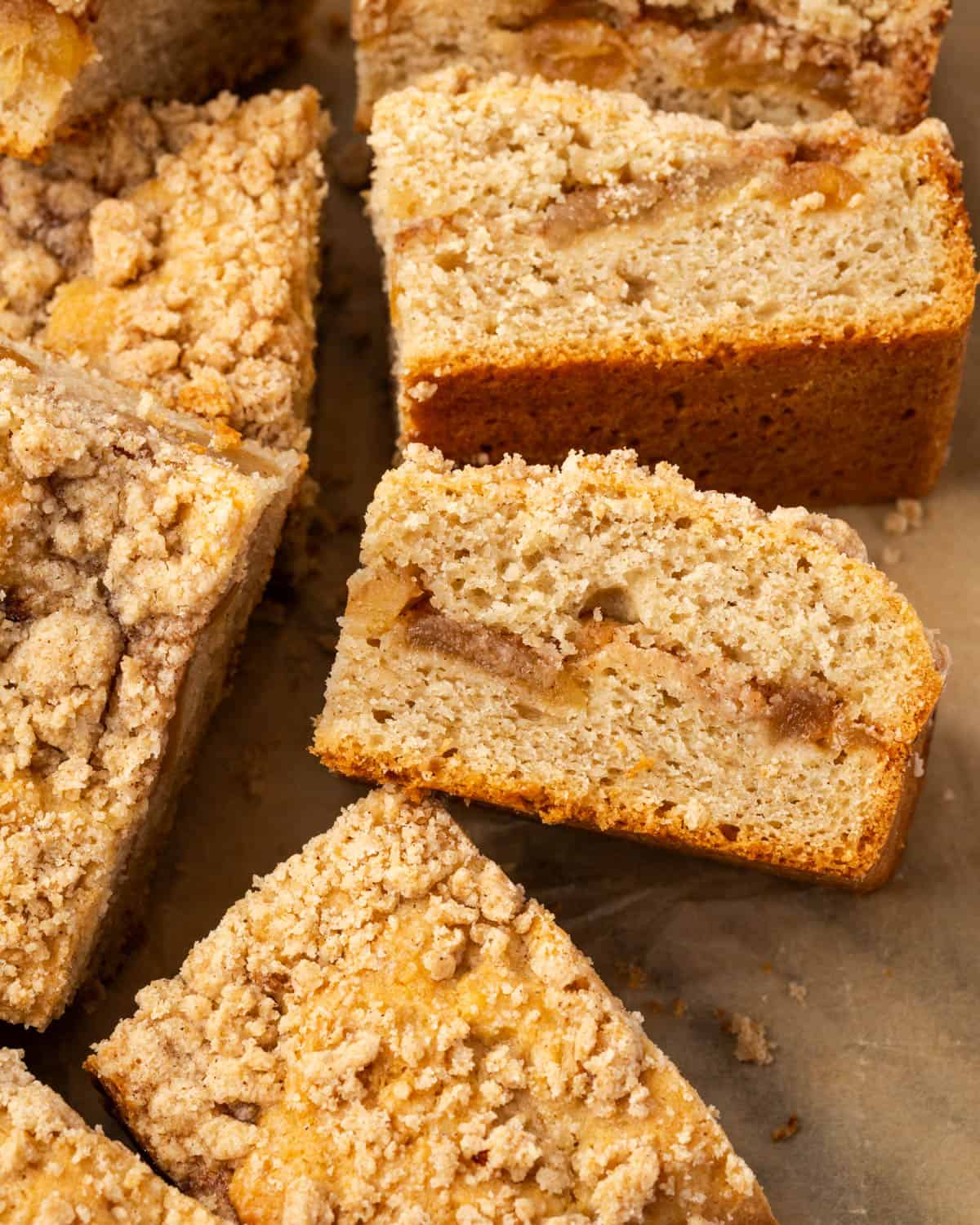 Several slices of apple cinnamon coffee cake sitting on a marble counter.