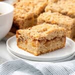 A slice of apple cinnamon coffee cake served on a small dessert plate.