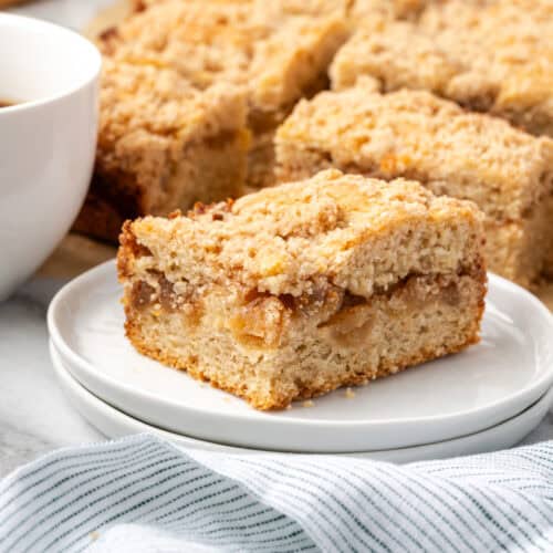 A slice of apple cinnamon coffee cake served on a small dessert plate.