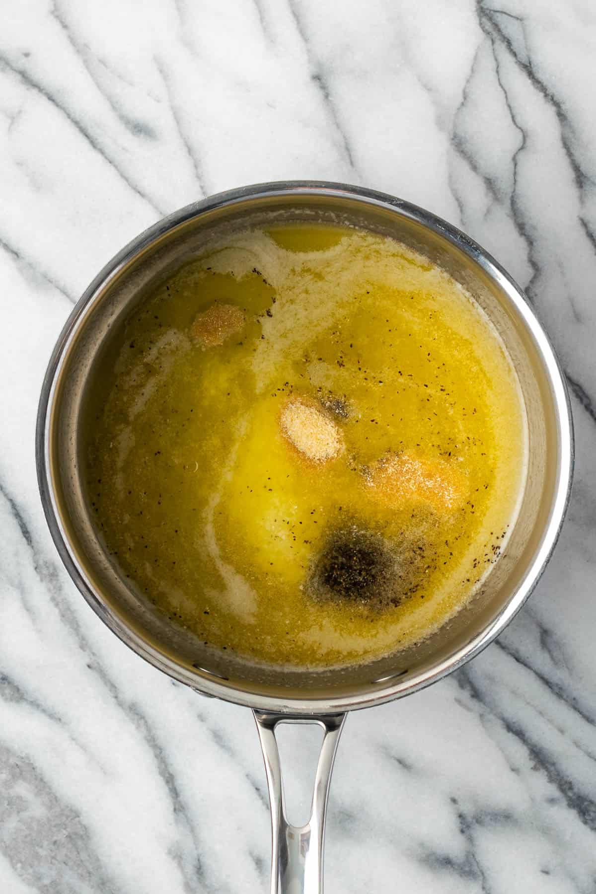 Melted butter, onion powder, salt and black pepper in a saucepan. 