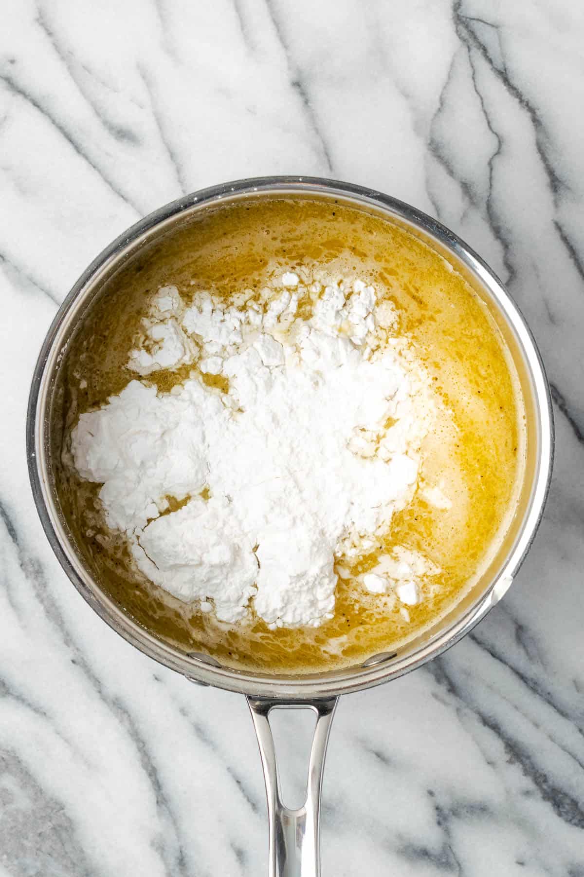 Chicken broth, milk, and tapioca starch added to the saucepan with the melted butter. 