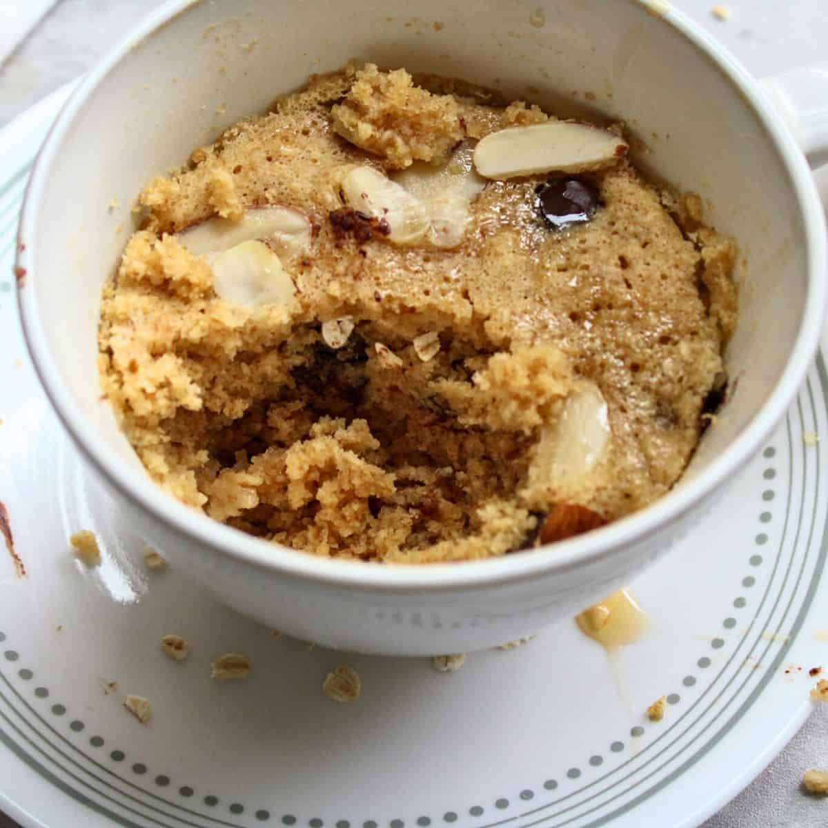An oatmeal mug cake topped with sliced almonds.