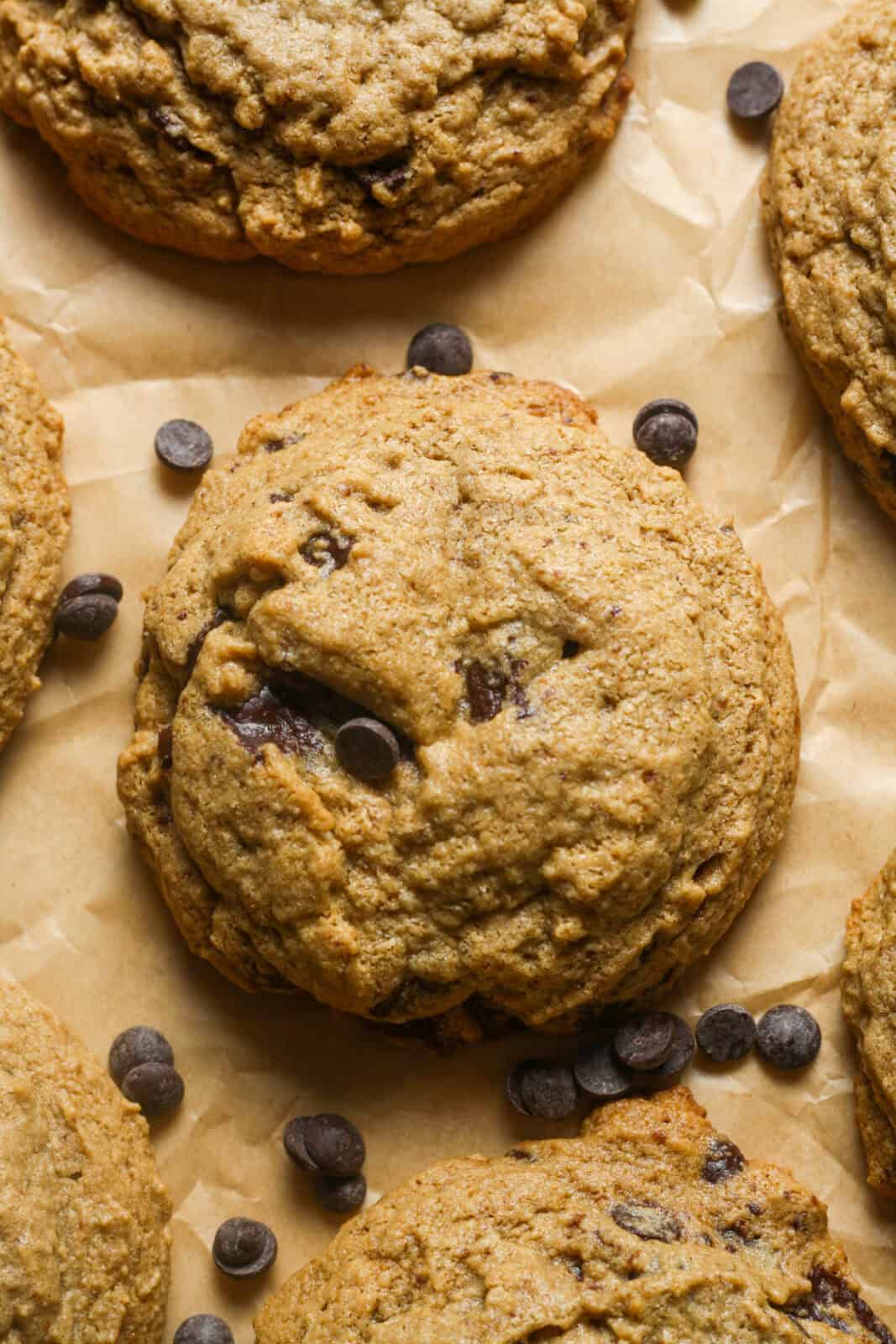Several oat flour chocolate chip cookies laying on a baking sheet.