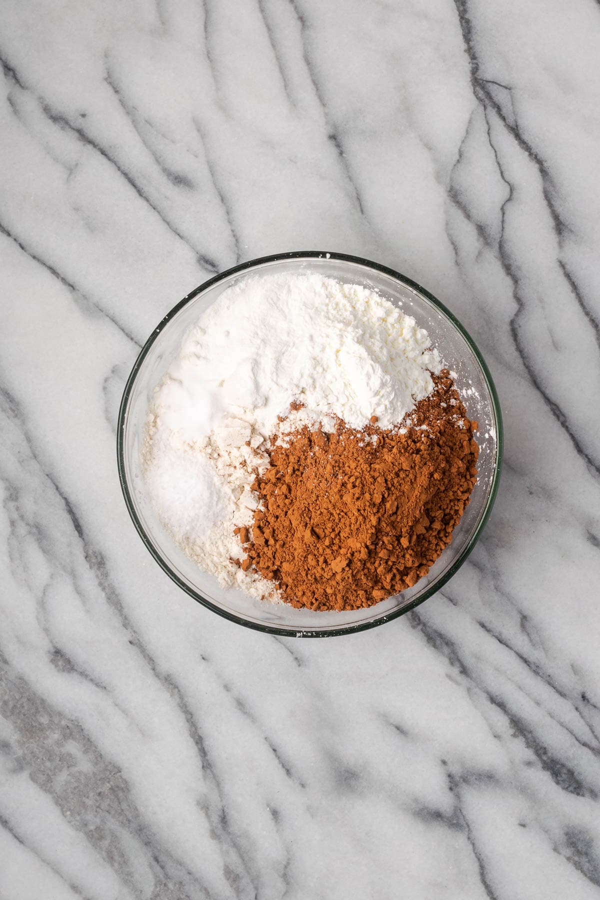 Flour, cocoa powder, cornstarch, baking powder, baking soda and salt combined in a small mixing bowl. 