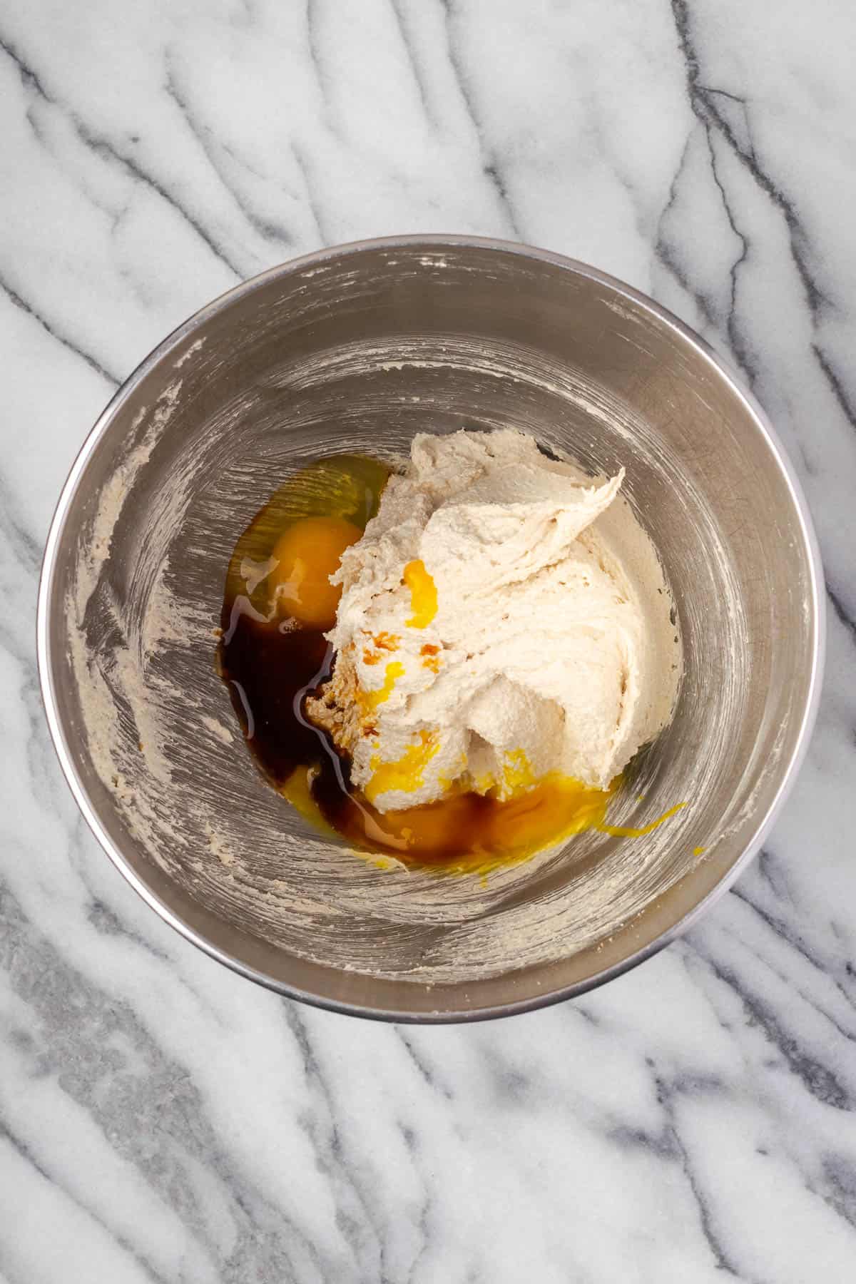 Eggs and vanilla extract added to the creamed butter and sugar.