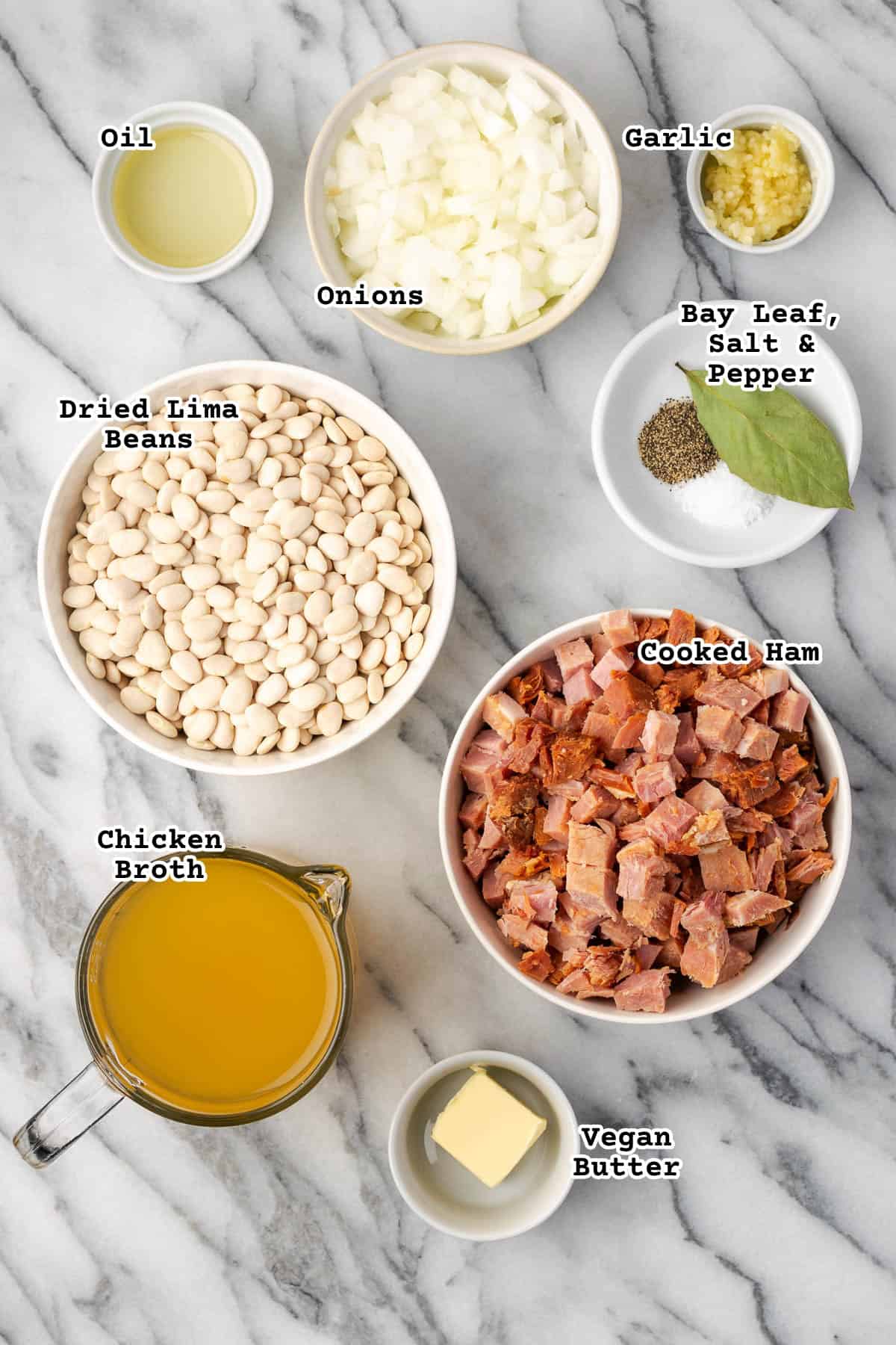 Ingredients for lima bean with ham sitting on a marble counter.