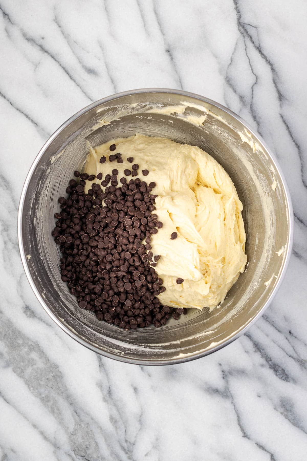 Mini chocolate chips being folded into the sour cream pound cake batter.