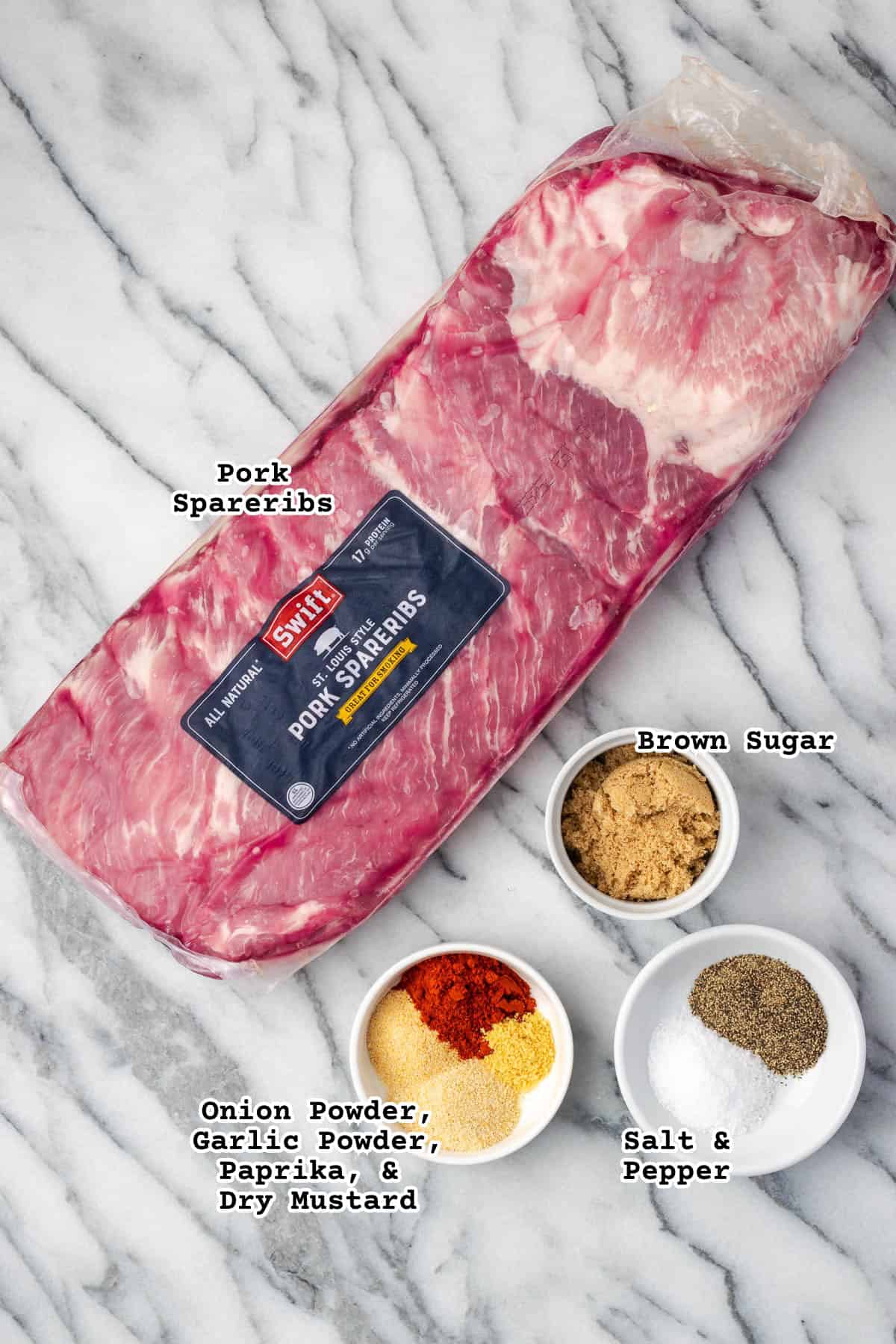 Ingredients for BBQ spareribs sitting on a marble counter.