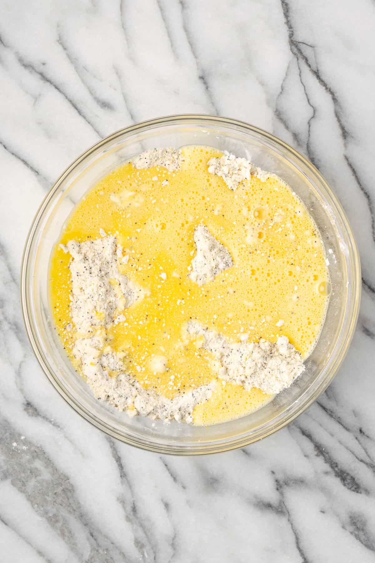 Wet ingredients poured into the large mixing bowl with the dry ingredients.