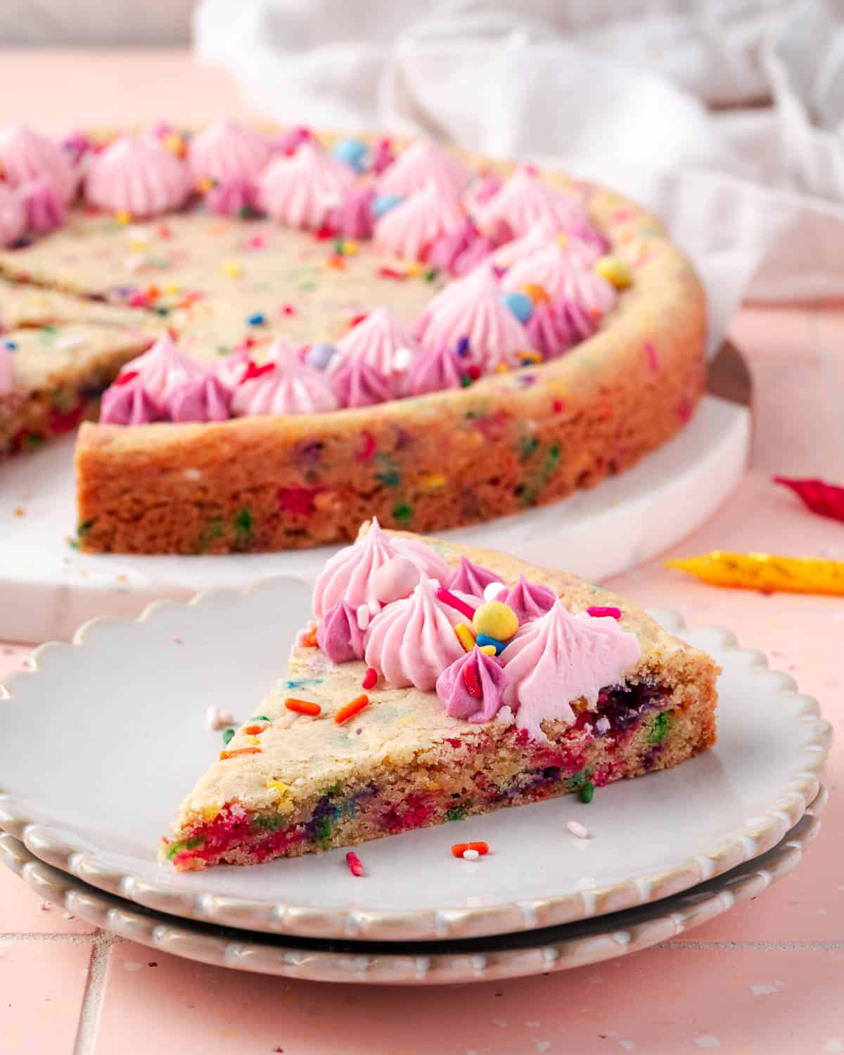 A slice of sugar cookie cake sitting on a small dessert plate.