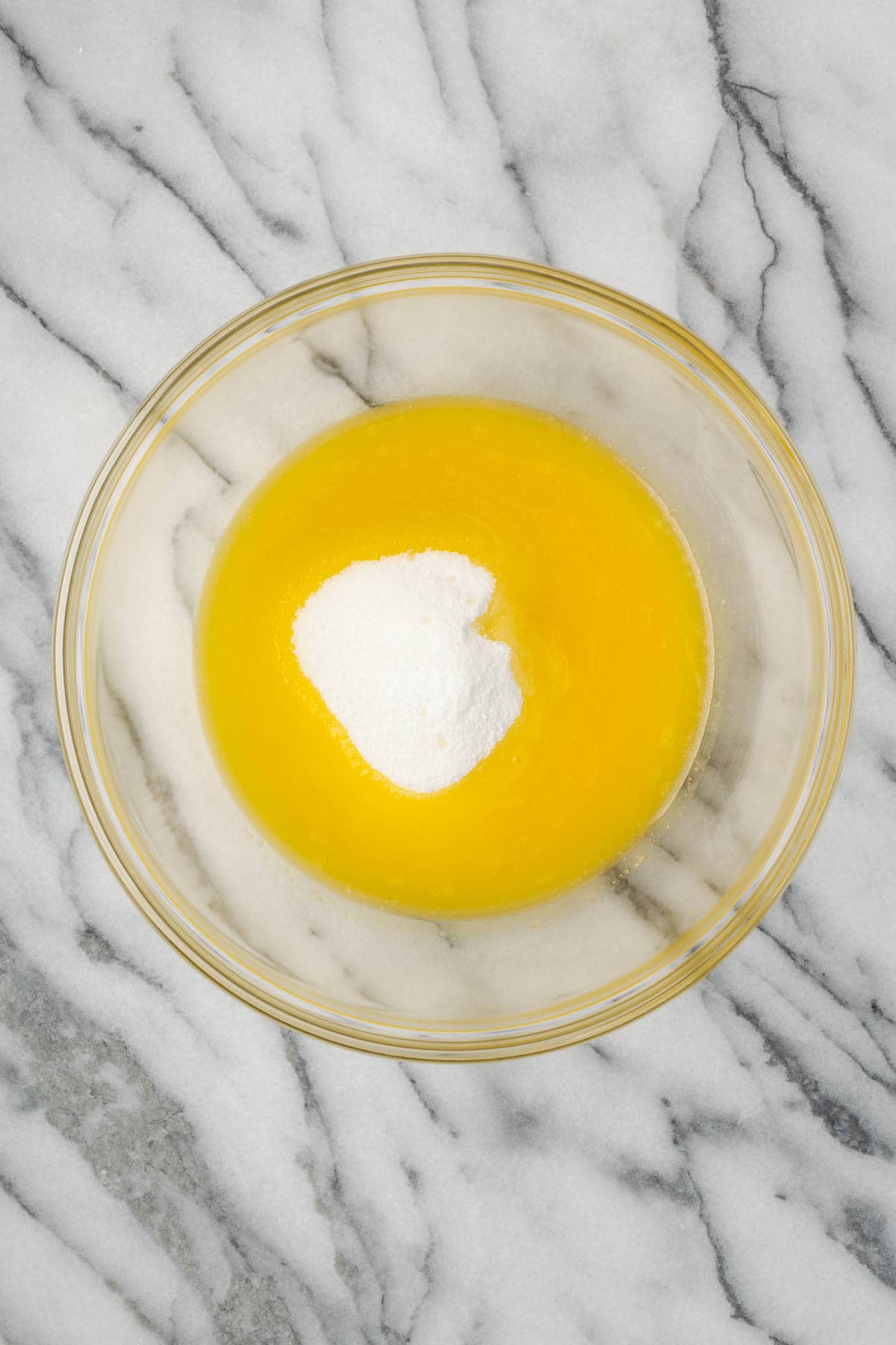 Melted butter and granulated sugar in a large mixing bowl.