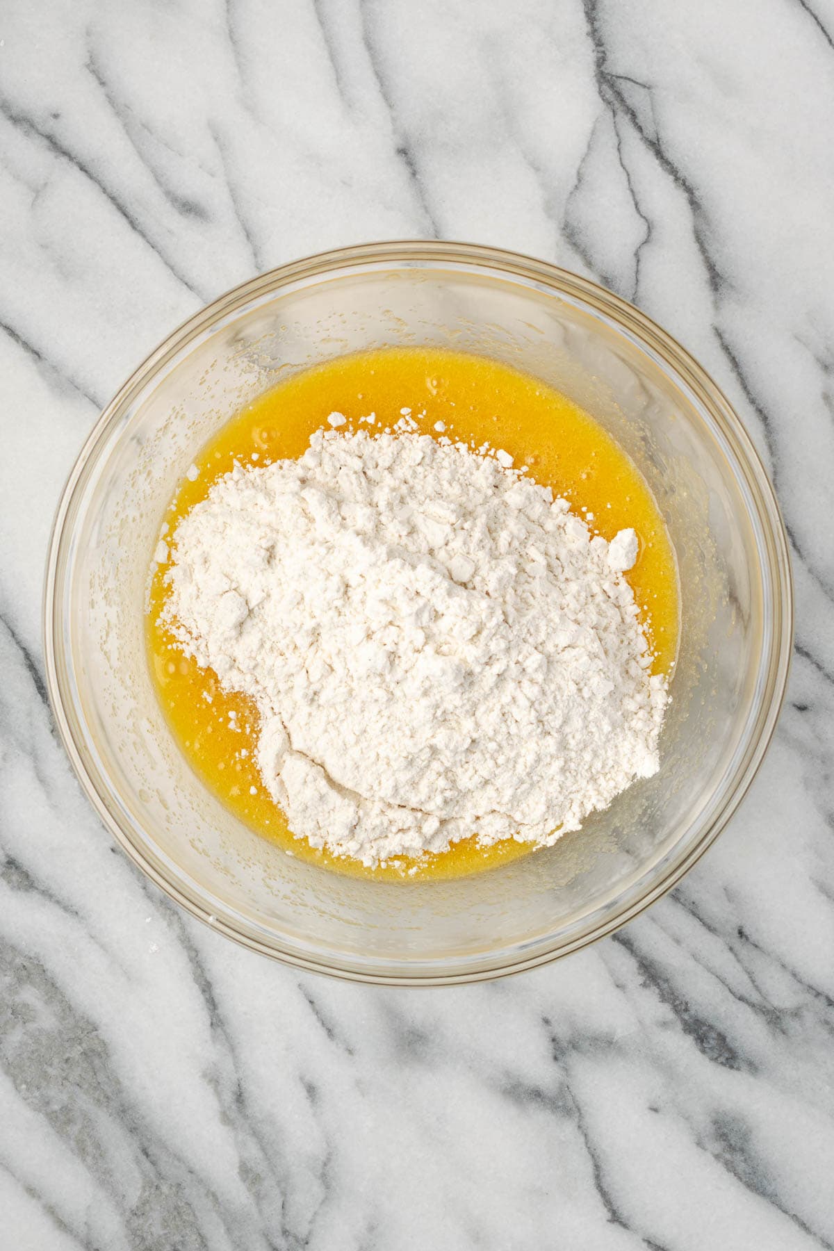 Flour, baking powder, baking soda, and salt added in to the partially mixed cookie dough.