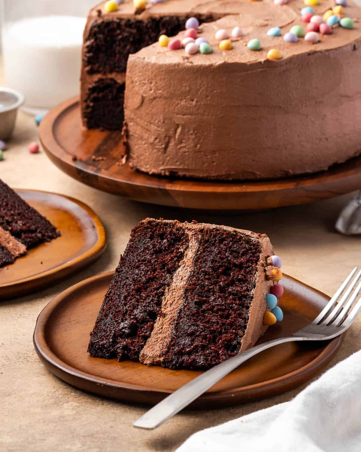 Two slices of gluten free chocolate cake served on small dessert plates.
