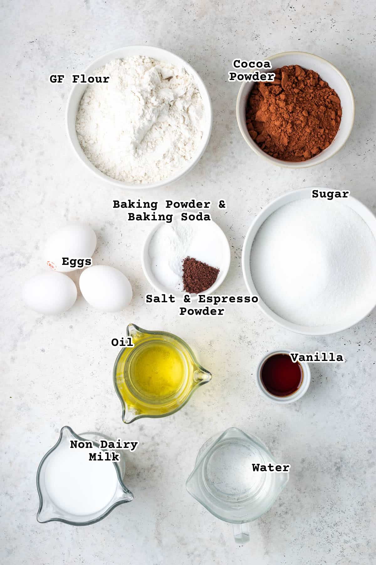 Ingredients for a gluten free chocolate cake sitting on a white counter.