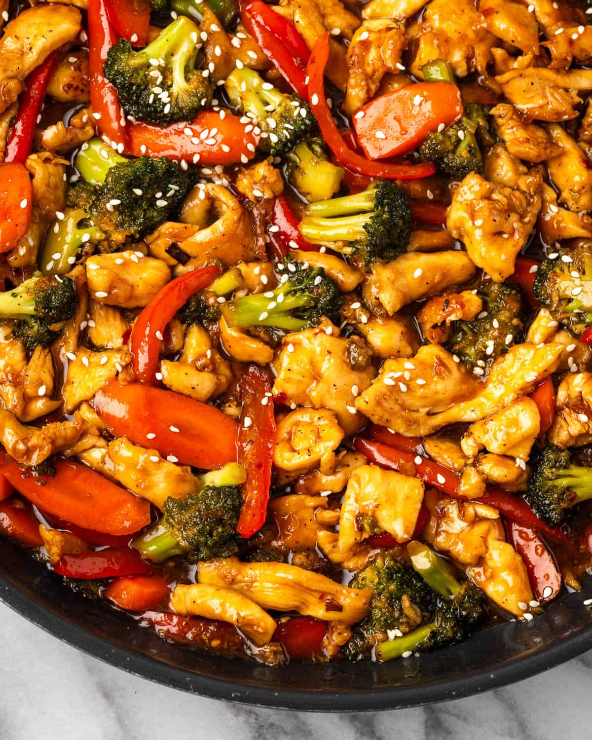 Chicken teriyaki with broccoli and carrots in a large skillet.