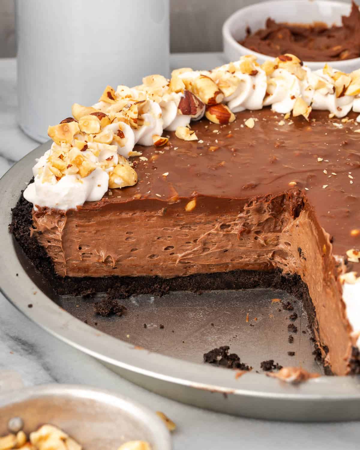 A sliced Nutella pie showing the creamy inside and the ganache layer on top. 