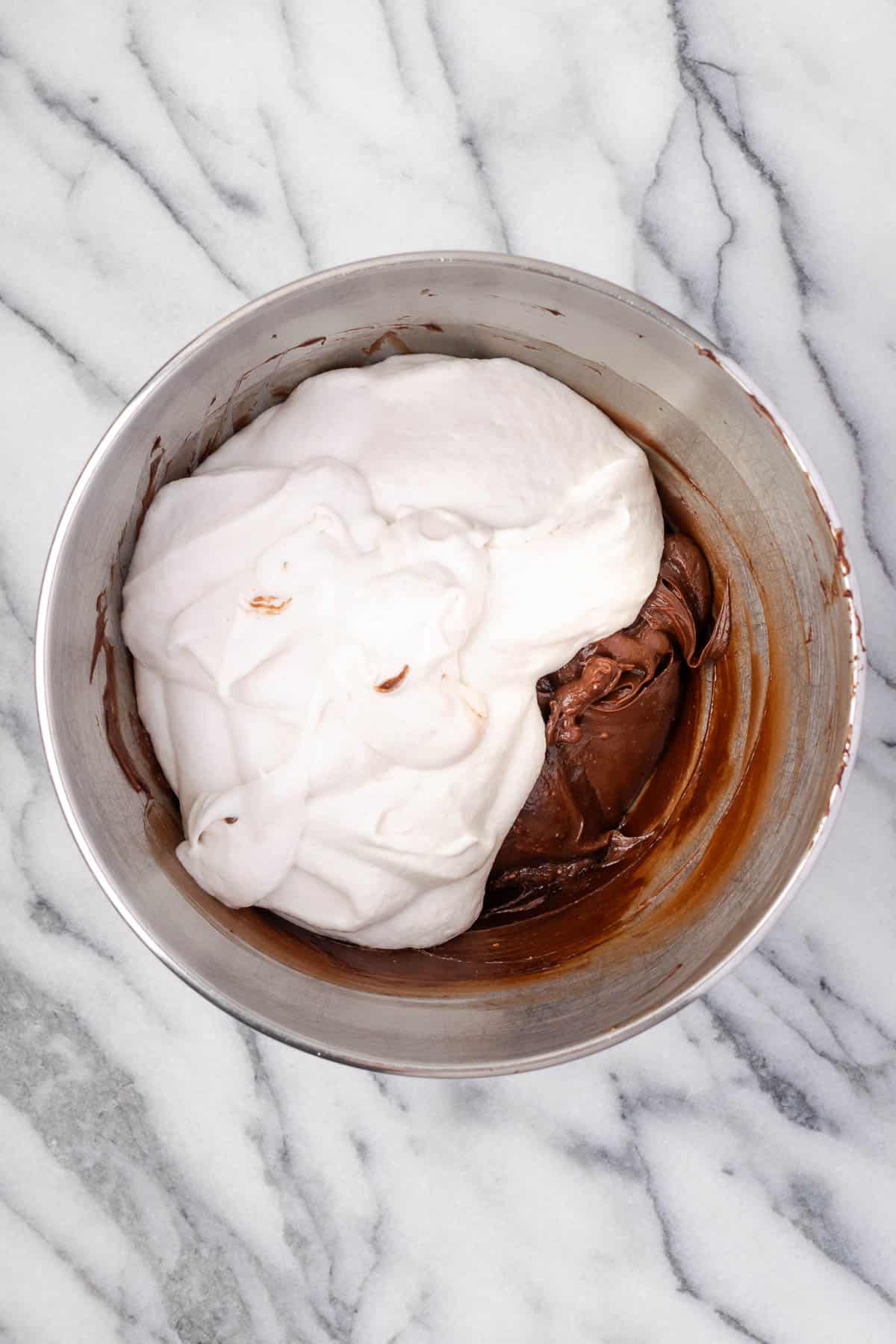 Whipped cream being stirred into the cream cheese mixture.