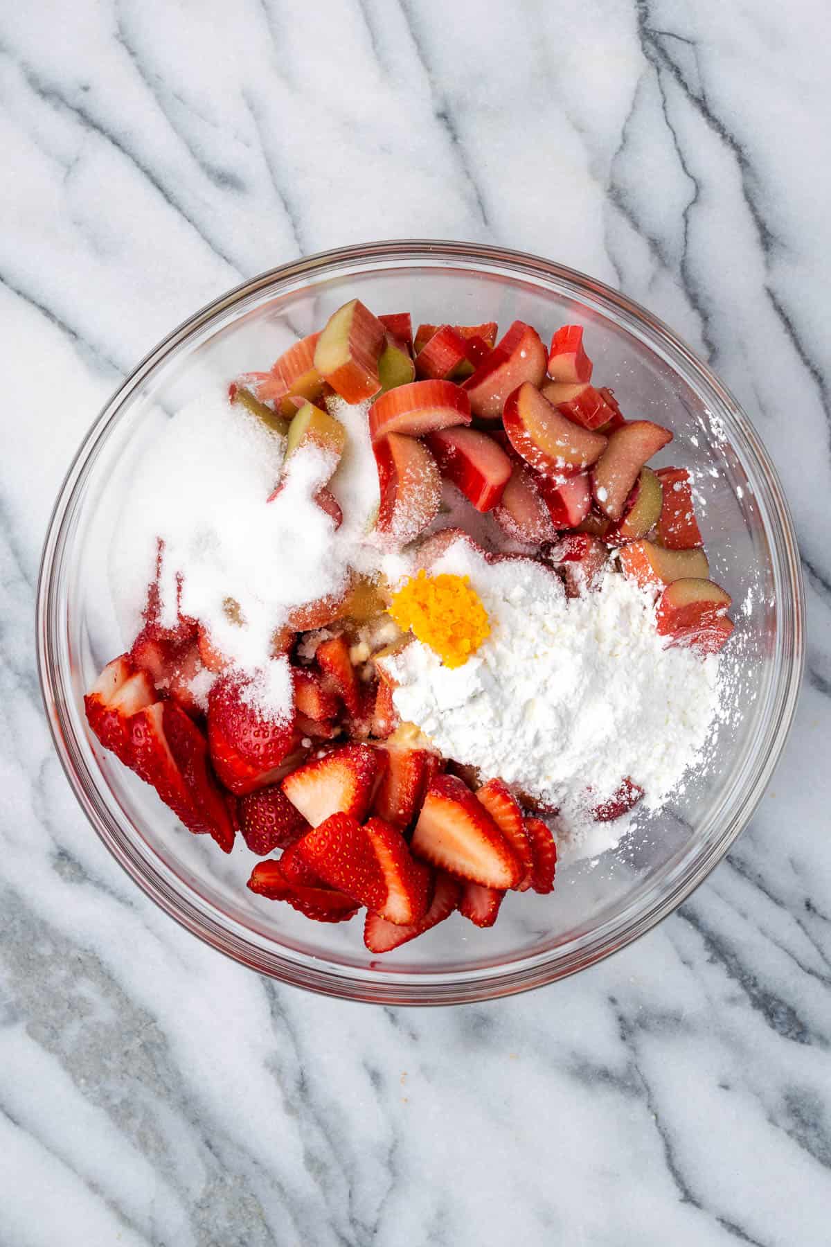 Sliced strawberries, rhubarb, sugar, cornstarch, salt, vanilla, orange juice and orange zest in a large bowl.