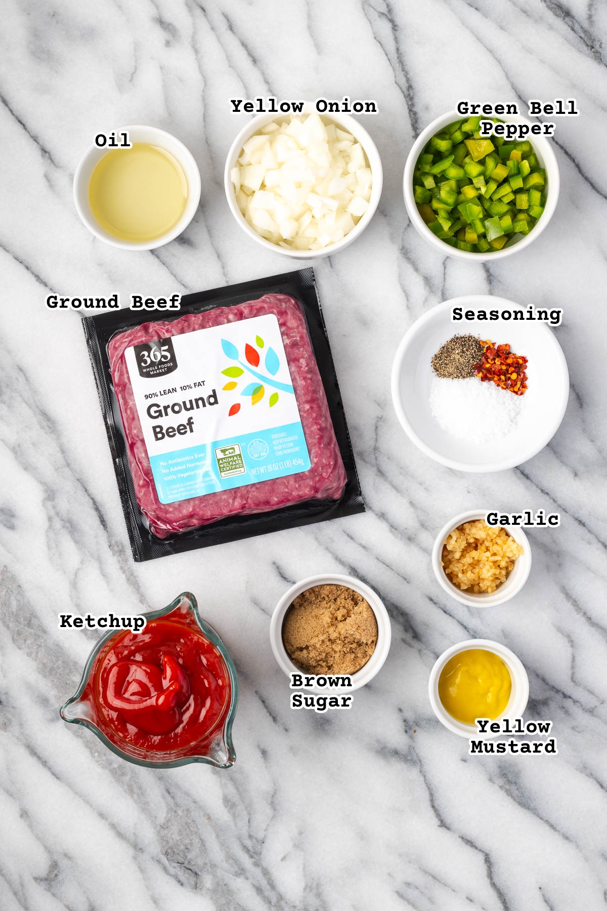 Ingredients for sloppy joes sitting on a marble counter.