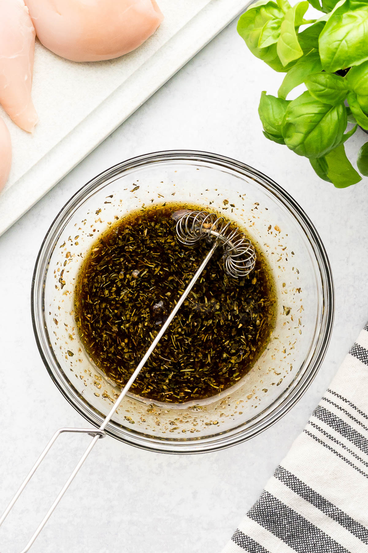 Marinade ingredients whisked together in a small glass bowl.
